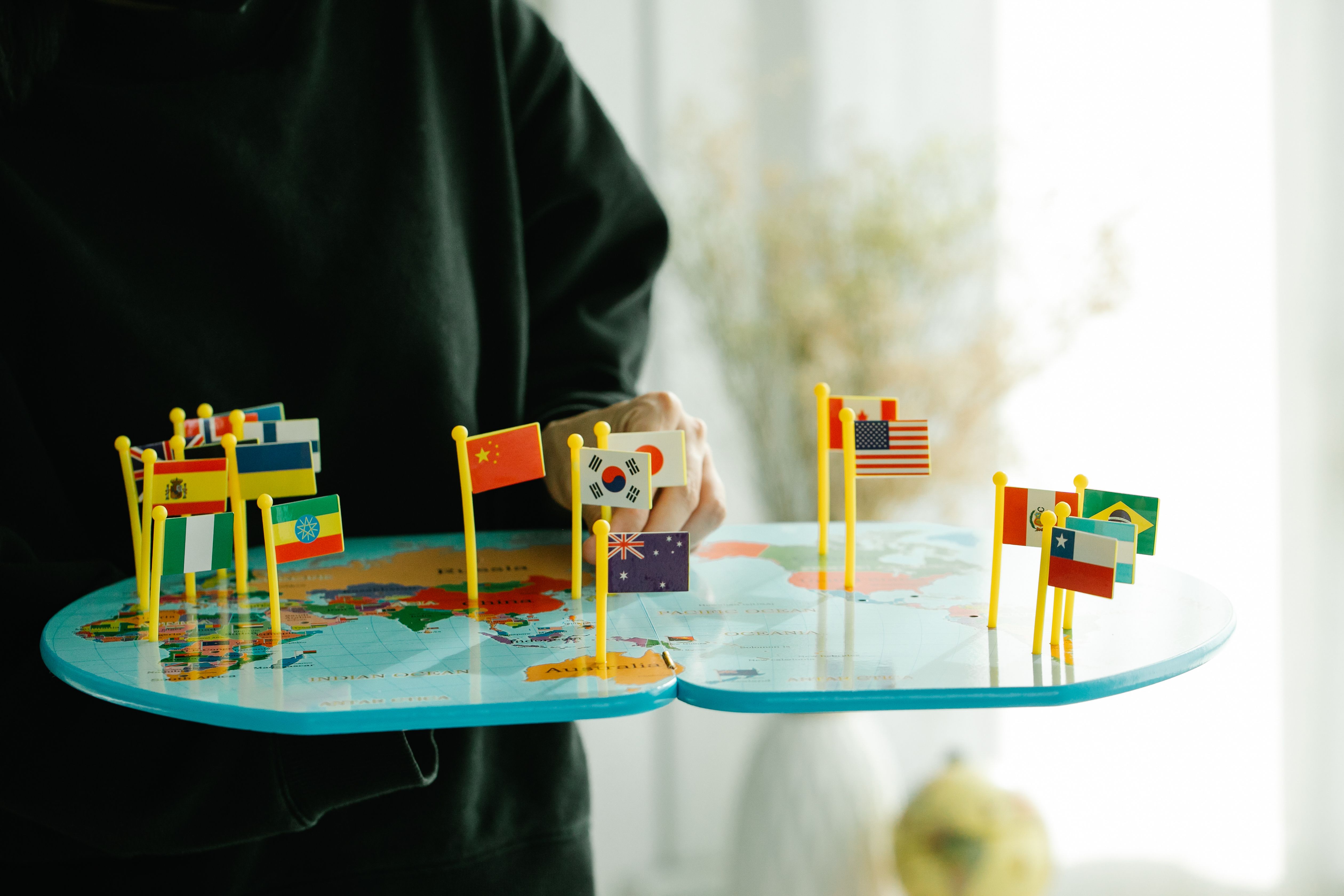 World map with miniature country flags representing a global comparison of nations