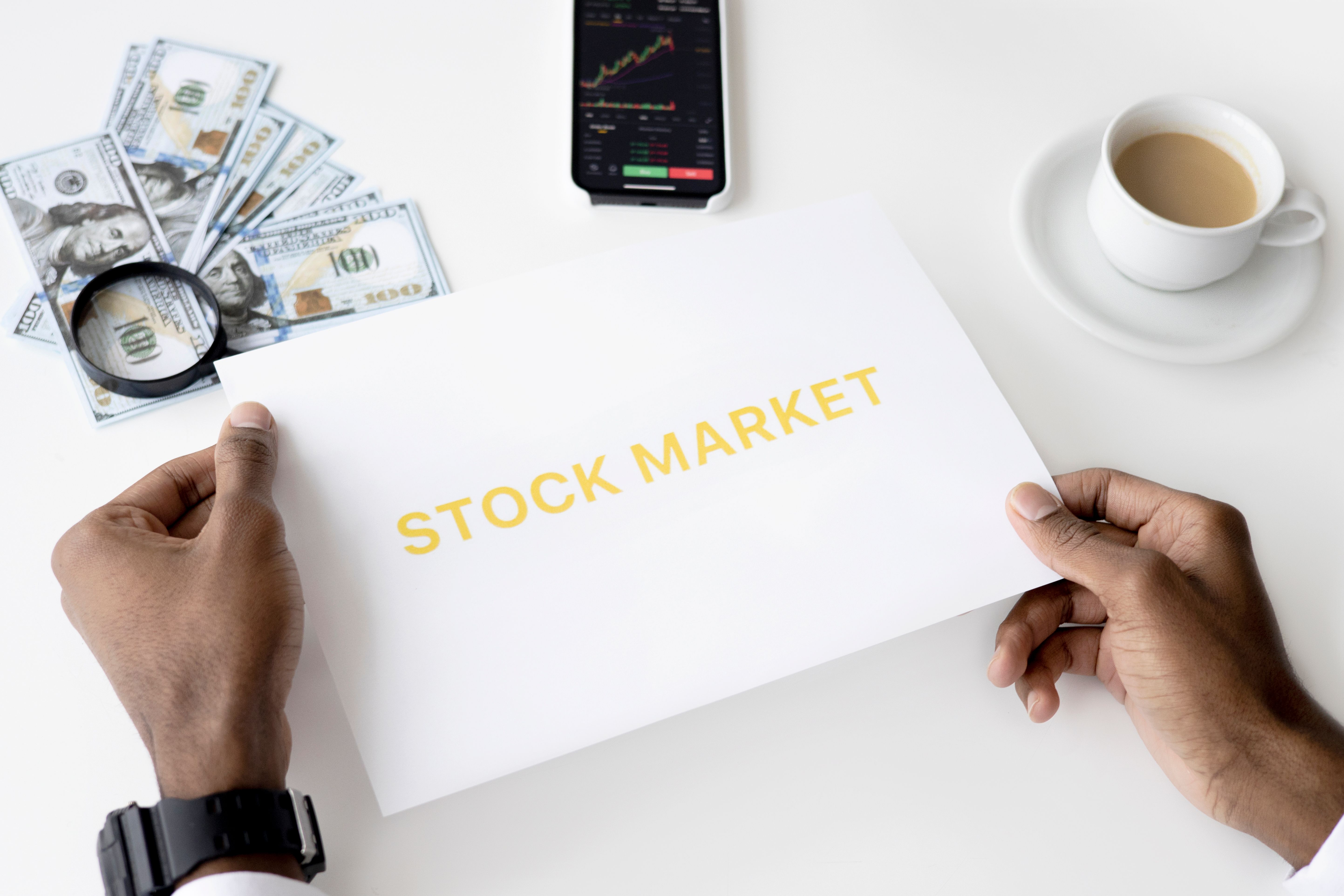 Stock market document with currency and a mobile chart illustrating investment diversification