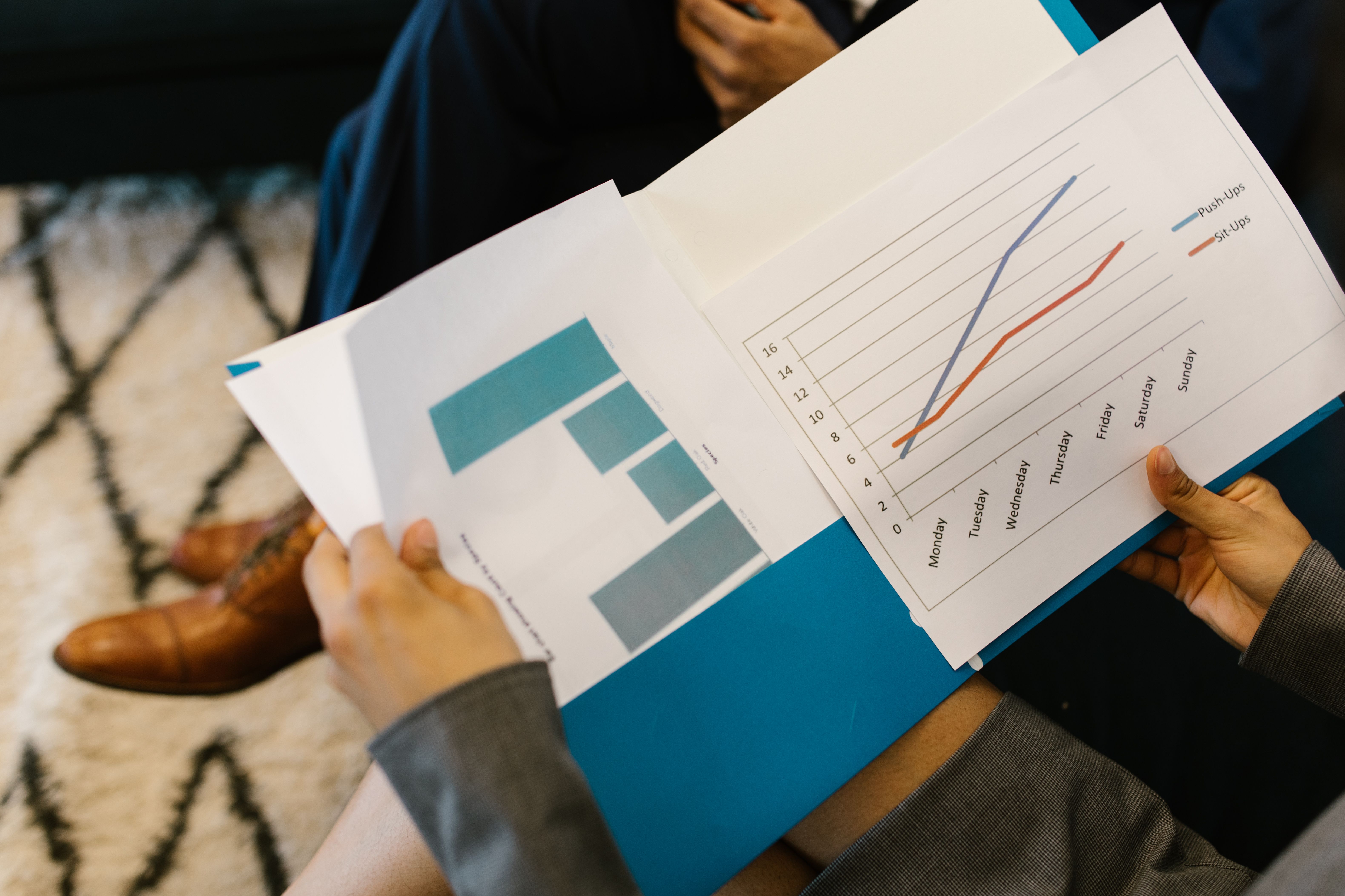 Business reports with graphs being reviewed at a corporate strategy meeting.